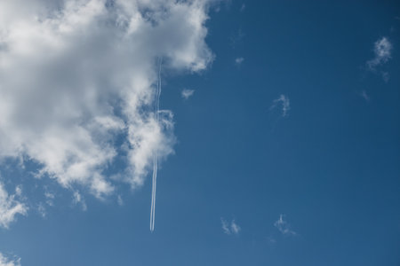 white cloud and a aircraft trail on blue sky in the natureの写真素材
