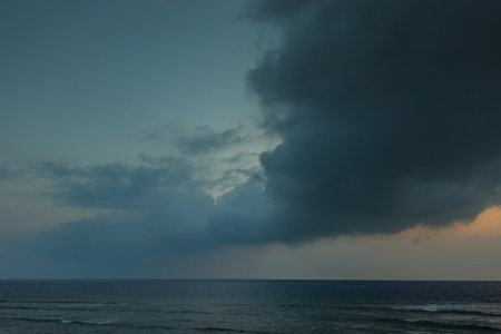 storm front with dark clouds and rain at the red sea in egyptの写真素材