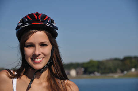 Girl is inline-skating at the lakeの写真素材
