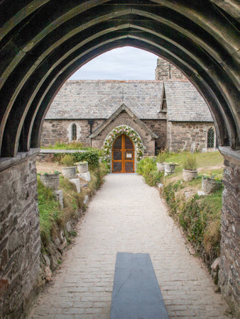 Flower decorated entrance of St. Enodoc Church in Cornwallの写真素材