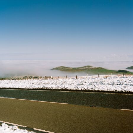 View to Scotland from the english, scottish border with green hills, fog in the valley and a clear...