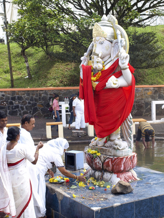 GRAND BASSIN, MAURITIUS - FEBRUARY 24, 2011: Pilgrims pray before the Statue of the Hindu god Ganesha during the Hindu festival of Maha Shivaratri in Mauritius.のeditorial素材