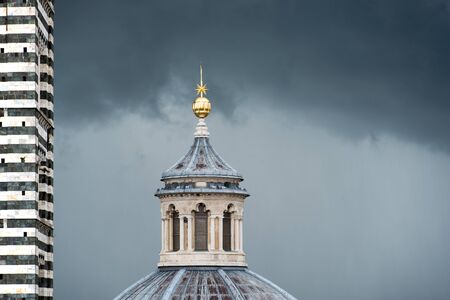 Upper part of the dome of the cathedral in Sienaの写真素材