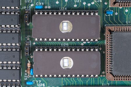 Extreme closeup of two EPROMÃ,Â's on an old computer board used in the 1980th.