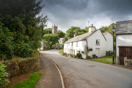 Street view with an old cottage and the church in the picturesque village Altarnun in north Cornwall.の写真素材