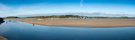 Panorama of the Camel estuary at low tide with the touristic village Rock in Cornwall. View from Padstow on the opposite site of the estuary.の写真素材