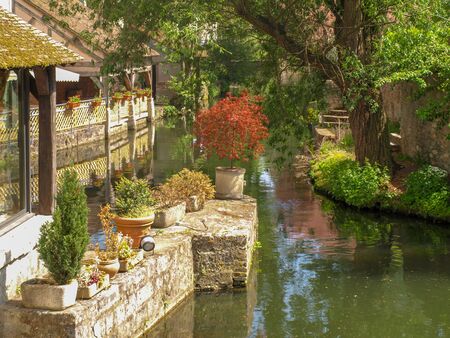 River L'Eure with flowerpots and bushes in the old town of Chartres in Franceの写真素材