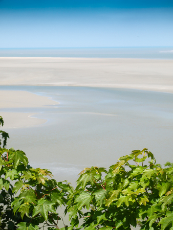Sandy beach, view from a walk around Mont Saint Michel.の写真素材