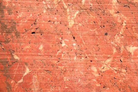 Red marble wall in an abandoned quarry in the eastern alps near Winzendorf in Austria.