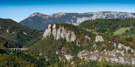 Viaduct and tunnel on the Semmering Railway with the Rax mountain range in the background. The...