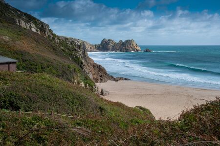 View of Porthcurno Beach in south Cornwall on a cloudy September day.の写真素材