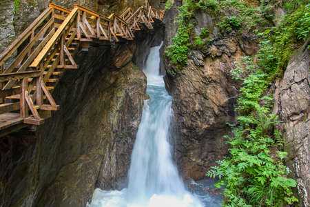 Walking through the Sigmund-Thun Klamm with wooden walkways near Kaprun in Salzburg, Austriaの写真素材