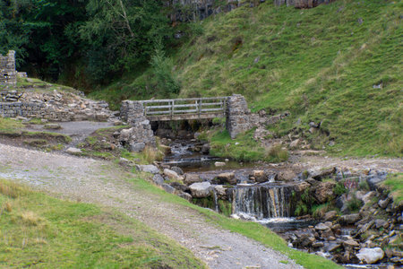 Footbridge at Fair Yew End in the Swinner Gild, which is a wild and remote area in the Swaledale in the Yorkshire Dales National Park.の写真素材