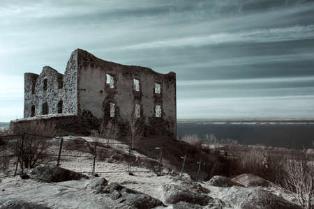  The ruin of a building on a sandy hill, overlooking the ocean 