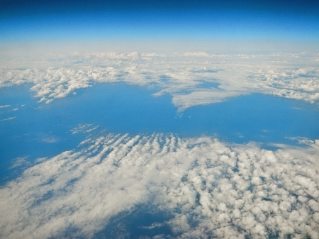 A picture of a cloudscape seen from above, shot from an airplane の写真素材