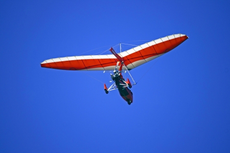 A picture of an air trike seen from the behind, in flight against the blue sky 