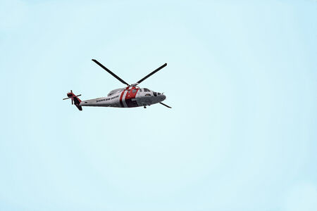 A picture of a rescue helicopter in the light blue sky 