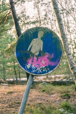 Walk way sign, worn and with graffitti on itの写真素材