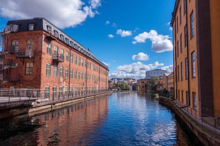 Norrkoping, Sweden - September 5, 2016: Motala river cuts through Norrkoping city, many of the buildings by the water is from Norrkopings textile industry era which ended in the 1950-tiesのeditorial素材