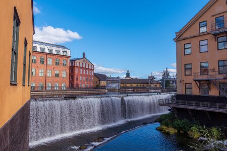 Norrkoping, Sweden - September 5, 2016: Motala river cuts through Norrkoping city, many of the buildings by the water is from Norrkopings textile industry era which ended in the 1950-tiesのeditorial素材