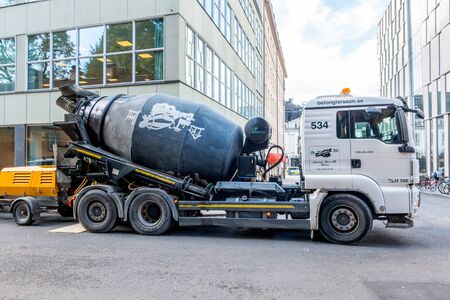 Stockholm, Sweden- October 5, 2017: White  and black Concrete mixer truck parked in the street