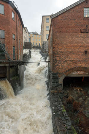 Molndal, Sweden - December 26, 2017: Molndal river waterfall in the old industrial  part of Molndal