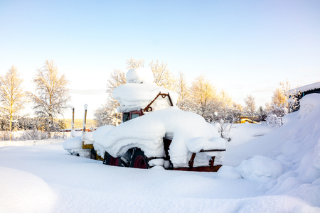 Kiruna, Sweden - February 3 2018: Parked tractor with heavy snow on topのeditorial素材