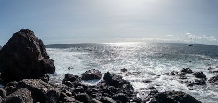 La Gomera  a rocky beach with the sunの写真素材