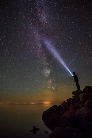 Milkyway and a man with a torchlight.の写真素材