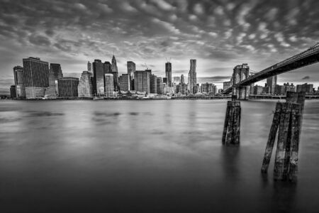 Interessting cloudscape over the New York skyline viewed from Brooklyn Bridge Park, USAの写真素材