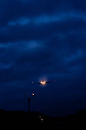 airplane landing in the darkの写真素材