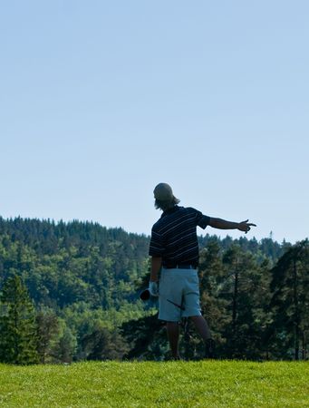 Male golfer signaling fore right after tee shotの写真素材