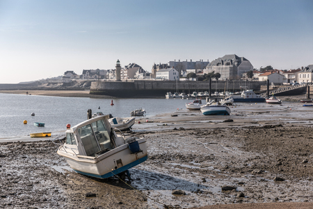 Boat at low tide in the Saint-Gilles Croix de Vie harbor (France)の写真素材