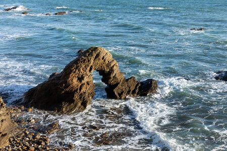 Rocky arch on the coast of la Pointe du Payre in Jard sur Mer (Vendee, France)の写真素材
