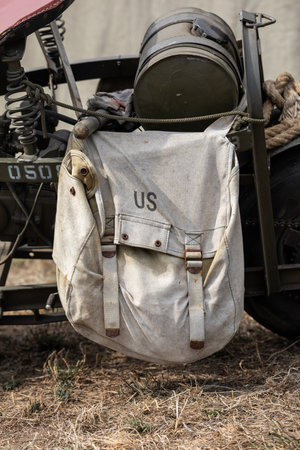 U.S military bag hang on a green old motorbike for World War 2 historical reenactment