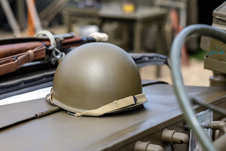 Green military combat helmet on an old vehicle for World War 2 historical reenactmentの写真素材