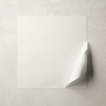Blank sheet of paper on a white wall. Mockup.の素材