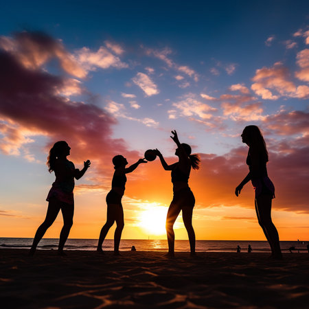 Silhouette of a group of young women dancing on the beach at sunset.の素材