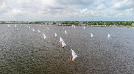 A line of small sailboats in a match on the Sneekermeerの写真素材