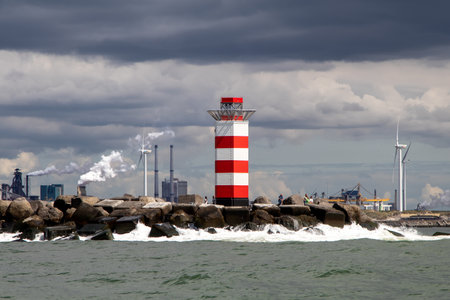 North harbour entrance lighthouse in IJmuiden under storm skiesの写真素材