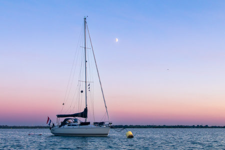 Sailing boat anchored with dramatic sunsetの写真素材