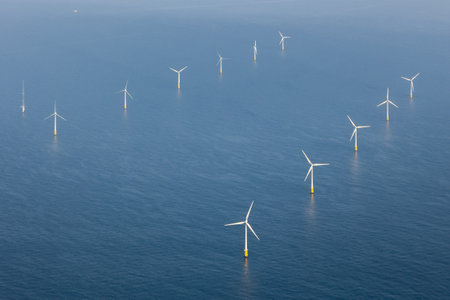 An image of windturbines in the mediterranean sea.