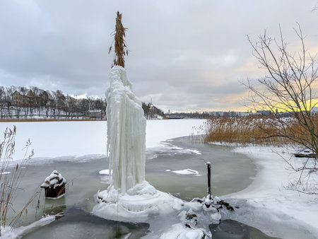 Frozen lake in winter with snow and icicles. Winter landscapeの写真素材