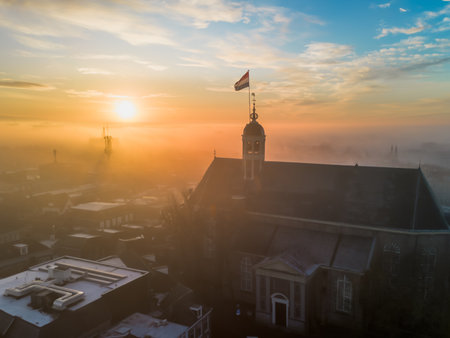 Dutch flag on the top of the church in the morning mist.の写真素材