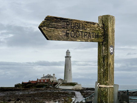 Wooden signpost with a lighthouse on the north coast of Scotlandの写真素材