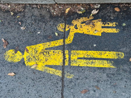 Yellow sign, marking or symbol of a 2 pedestrians on a path on black asphalt. High quality photoの写真素材