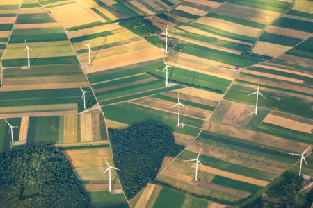 Many windmills or wind turbines for green, renewable, energy or electricity on a hilltop between...