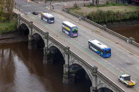 Top down, above view of the Central Glasgow bridge across the river Clyde with a few pedestrian on...
