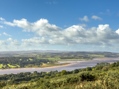 Summer view near river and grass highlands in Scotland with water and rolling hills