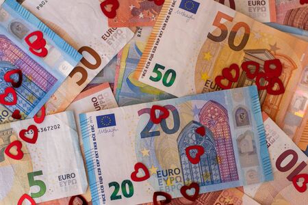 Euro banknote background, covered by hearts, we love moneyの写真素材